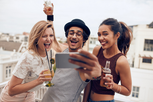 Friends taking a selfie on rooftop party